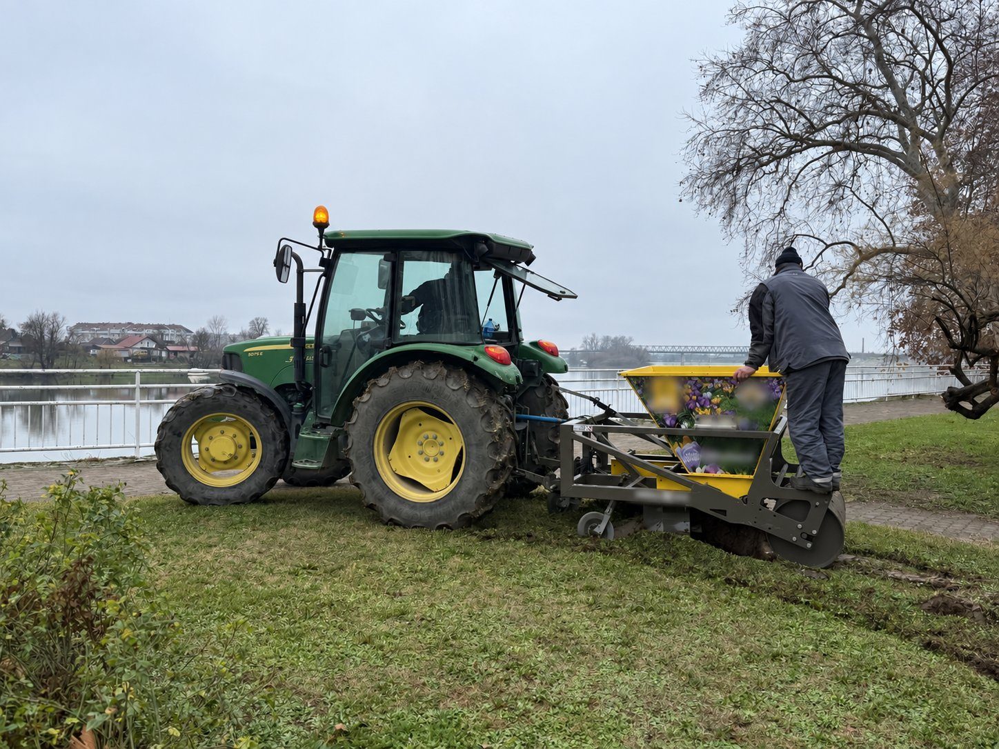 Traktor s sadilnim strojem na travnati površini v Hrvaški